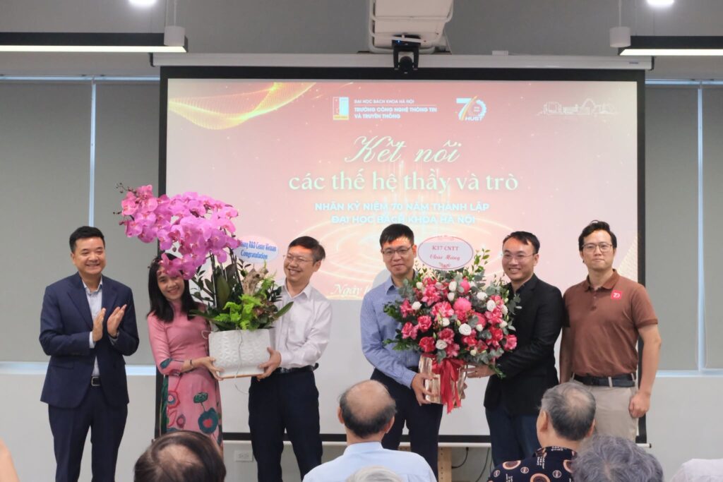 Presenting flowers in appreciation at the School of Information and Communication Technology.